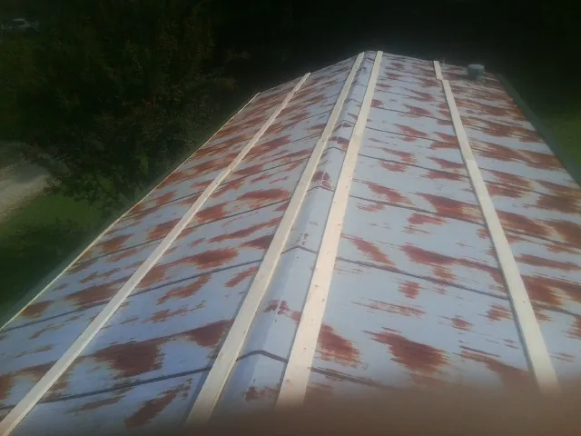 Rusted metal roof panels with new wood purlins before replacement — Storm Damage Roof Repair in Corbett by Roofing Brothers